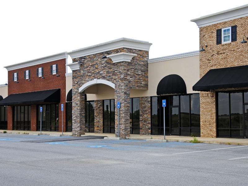Commercial property with multiple storefronts and parking areas in Mobile, AL for an adjacent parcel property survey.
